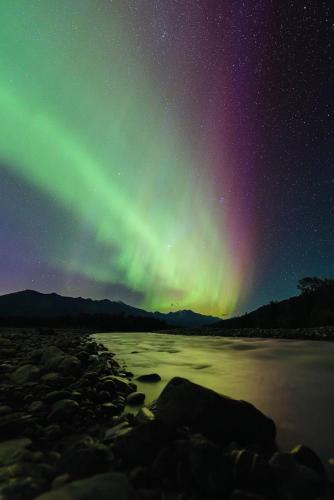 an aurora in the sky over a body of water at Alaska Getaway in Palmer