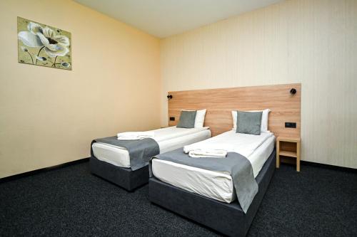 a hotel room with two beds in a room at Complex Magiyata na Rila in Rilski Manastir