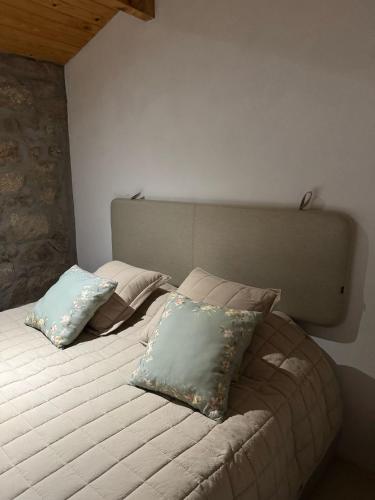 a bed with two pillows on it in a room at Quinta de Gandarem in Torre de Moncorvo
