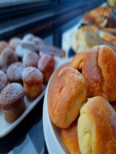 a plate of pastries and donuts on a table at Bel Mare Boutique Hotel in Batumi