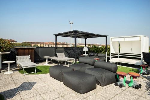 a patio with a couch and chairs and a gazebo at Best Western Plus Executive Hotel and Suites in Turin