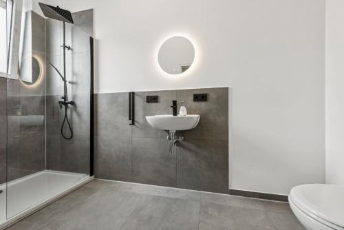a bathroom with a sink and a shower at Nordbrise by BohnApartments - Parkplätze - WLAN - Garten - ruhig in Diepholz