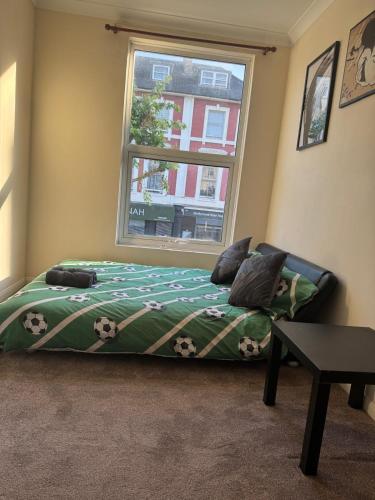 a bed in a room with a window at Smart Junction in Norwood