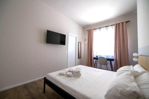 a bedroom with a bed and a television on the wall at Montebello Living in Ancona