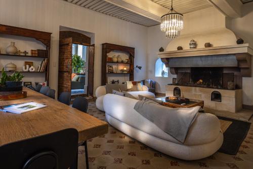 a living room with a couch and a fireplace at La Chapelle sur la Sorgue in LʼIsle-sur-la-Sorgue