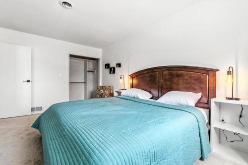 a bedroom with a large bed with a blue blanket at The Mulberry in Logan