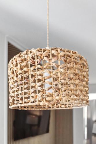 a rattan light fixture hanging from a ceiling at The Mulberry in Logan