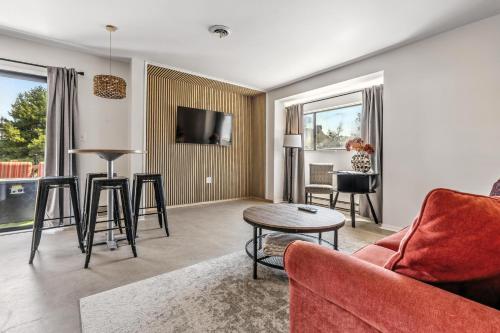a living room with a red couch and a table at The Mulberry in Logan