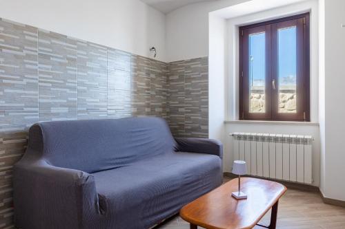 a living room with a couch and a table at Casa Belvedere - Affitti Brevi Italia in Poggio Picenze