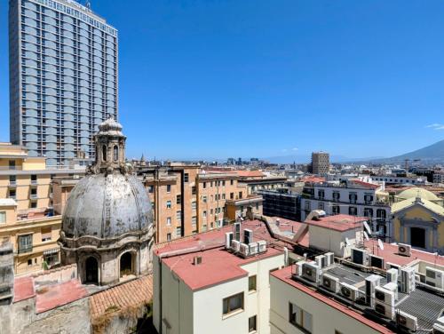 a view of a city with buildings and a dome at Incoming Municipio in Naples