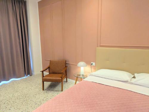 a bedroom with a large bed and a chair at Incoming Municipio in Naples