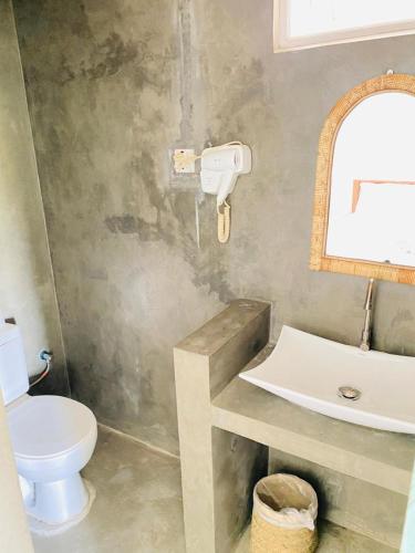 a bathroom with a toilet and a sink at Sky Breeze in Unawatuna