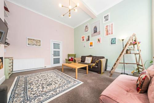 a living room with a couch and a table at Unique Victorian Home in Glasgow in Glasgow