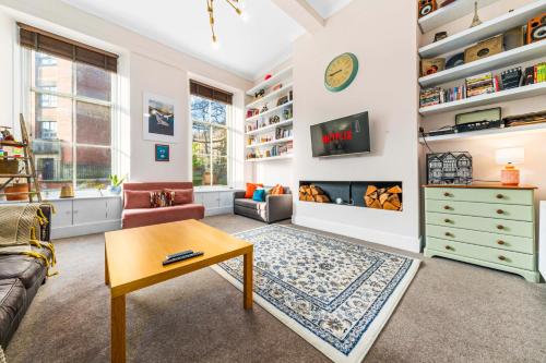 a living room with a couch and a table at Unique Victorian Home in Glasgow in Glasgow