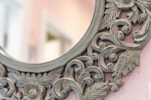 a mirror on the side of a pink wall at Unique Victorian Home in Glasgow in Glasgow
