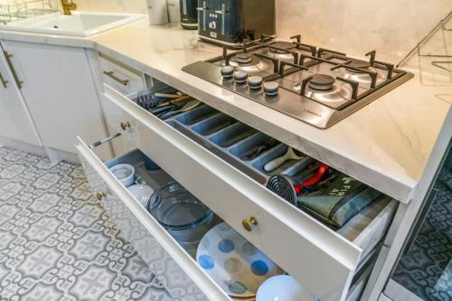 a stove top oven sitting on top of a kitchen drawer at Unique Victorian Home in Glasgow in Glasgow