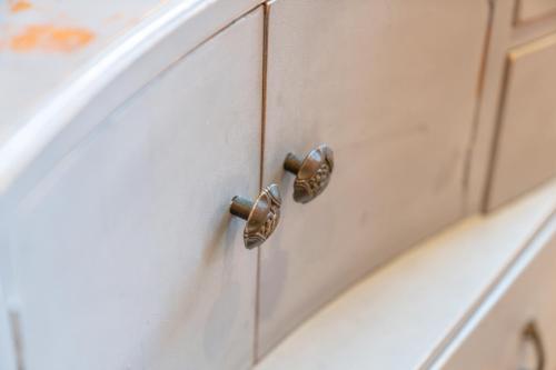 a white cabinet with metal knobs on it at Unique Victorian Home in Glasgow in Glasgow