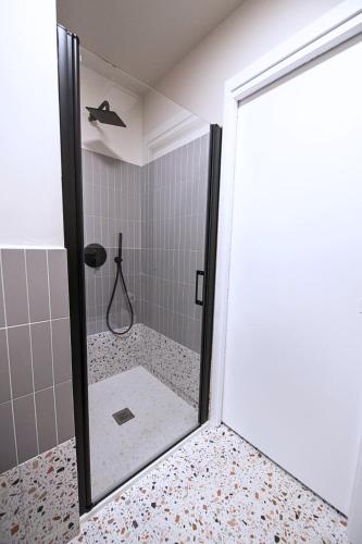 a bathroom with a shower with a glass door at Montebello Living in Ancona
