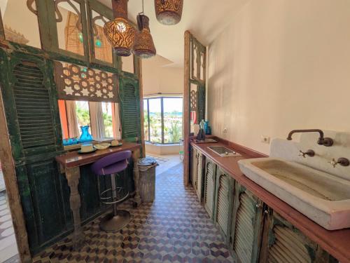 a bathroom with a tub and a table and a sink at Super Central Somabay 2BR Marina Apt w Free Beach in Hurghada
