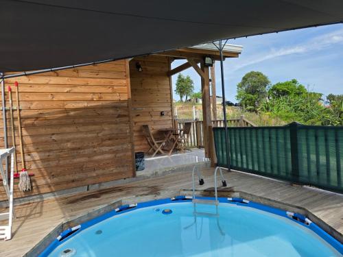 a hot tub on a deck next to a building at Haven Paradise in Sainte-Anne