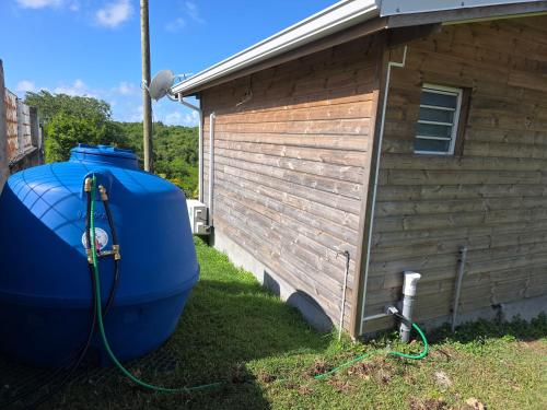 a large blue tub next to a building at Haven Paradise in Sainte-Anne