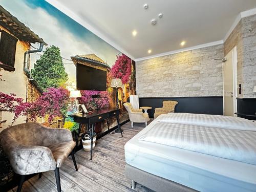 a bedroom with a king sized bed and a television at Designhotel Central Fulda in Fulda