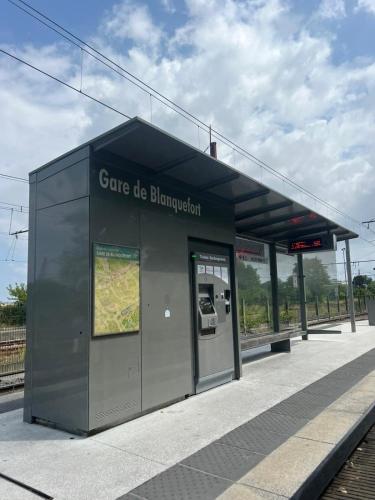 a bus stop with a building with a map at Idéal pour un séjour à Bordeaux in Blanquefort
