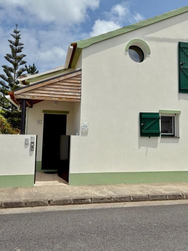 a white house with a door and a window at Casa dos Netos - Garden & Lake III (Sete Cidades) in Sete Cidades