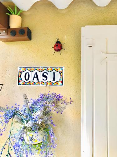 a sign on a wall with a lady bug on it at Oasi Des Mirabelles - Gîte in Mirabel-aux-Baronnies