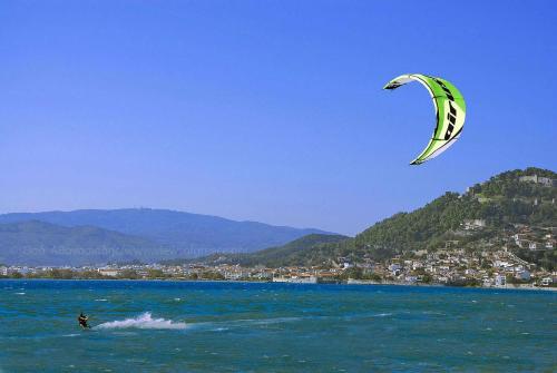 a person is kite surfing in the water at Helen's Seaside Apartment in Nafpaktos