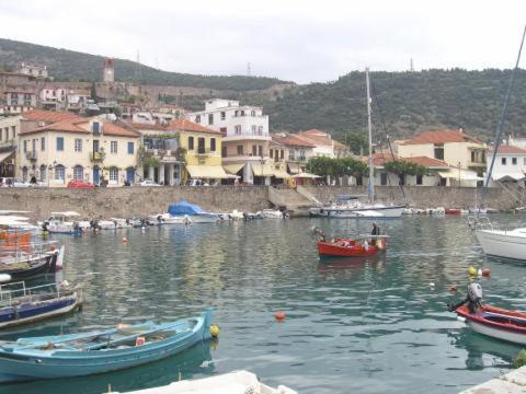 a group of boats in a harbor with buildings at Helen's Seaside Apartment in Nafpaktos