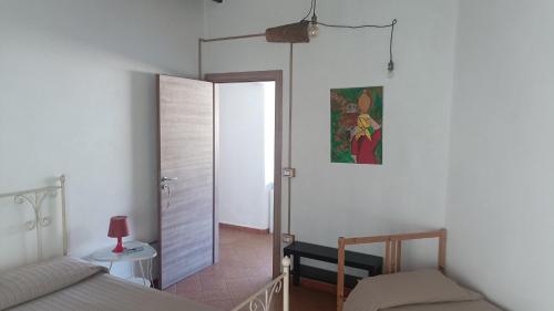a bedroom with a bed and a mirror and a door at LaGreka2025 in San Pantaleone