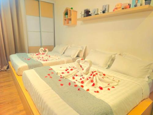 two beds in a room with red hearts on them at Symphony Tower - Balakong Seri Kembangan in Serdang