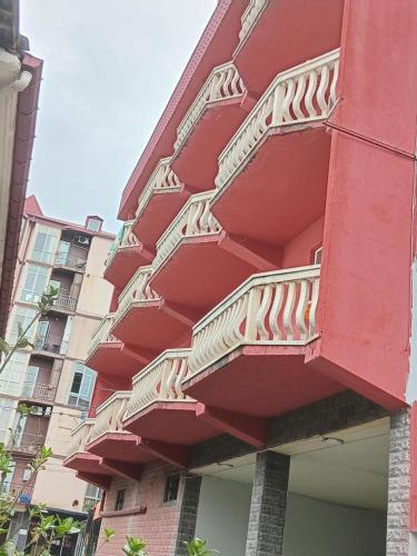 a red building with stairs on the side of it at Khatia's Guest House in K'obulet'i