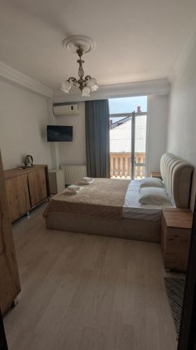 a bedroom with a large bed and a large window at Khatia's Guest House in K'obulet'i