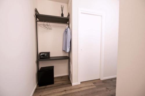 a closet with a black shelf and a door at Montebello Living in Ancona