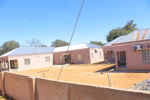a building under construction with a concrete lot at MB guesthouse in Kasane