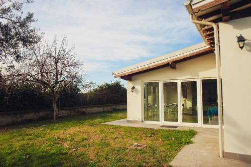 a house with a large sliding glass door at Guest House Montestallone in Formello