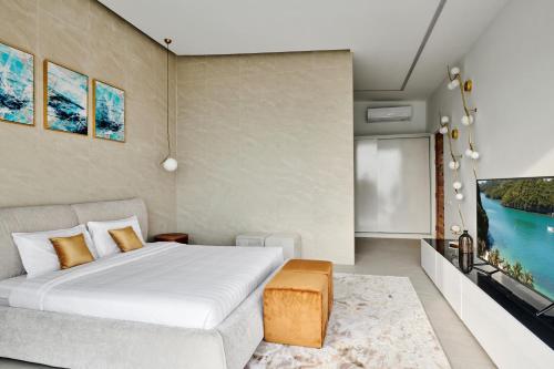 a bedroom with a bed and a tv at Icon Villa Samui in Nathon Bay