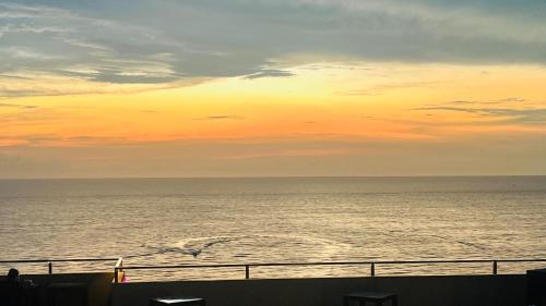 a view of the ocean at sunset from a ship at OCEAN BREEZE - WAVES LUXURY CONDO in Negombo