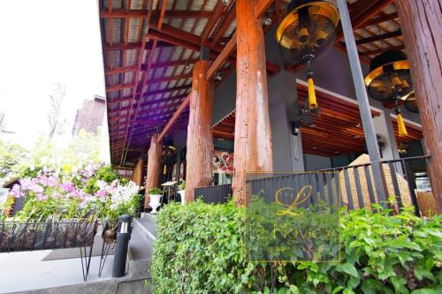 a building with a bunch of plants in front of it at Le Naview @Prasingh in Chiang Mai