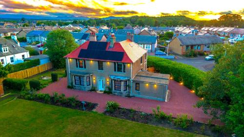 an aerial view of a house in a residential neighborhood at Red Roofs - 5BR Luxury - Large Gardens - EV Point - Near Edinburgh in Newtongrange