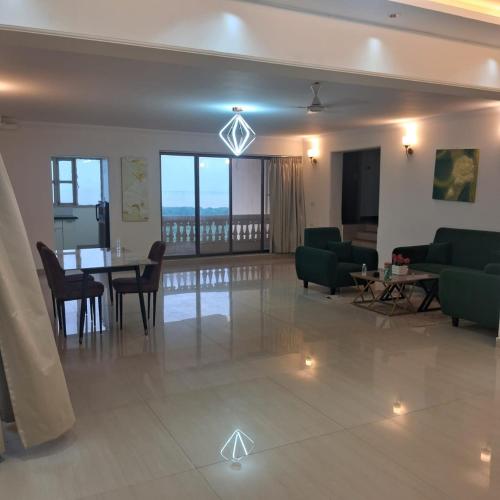 a living room with a table and chairs at Outstay Executive Apartments in Navi Mumbai