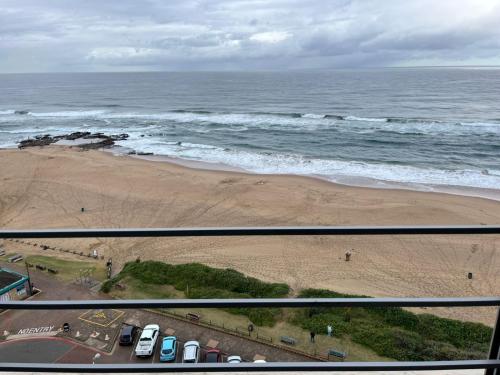 a view of a beach and the ocean with cars at Unit 102 Warnadoone in Kingsburgh