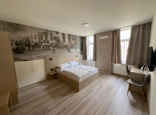 a bedroom with a bed and a desk in it at Hotel Evropa in Celje