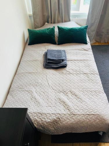 a bed with a towel on top of it at Linden apartment in Preiļi