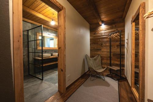 a room with a chair and a glass shower at Ca d' Vetu in Roccaforte Mondovì