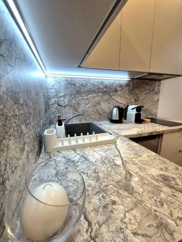 a kitchen with a counter with a glass bowl on it at Apartmány v srdci Ružinova in Trnávka