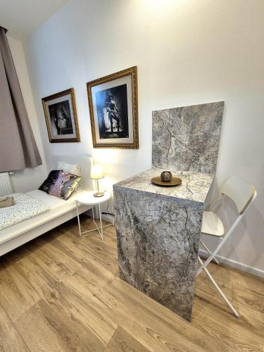 a living room with a couch and a marble table at Apartmány v srdci Ružinova in Trnávka