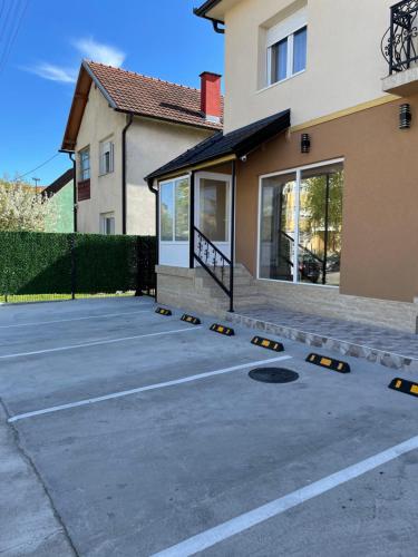 a parking lot in front of a house at Sobe Sara in Šabac